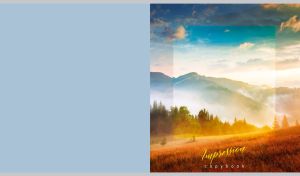 A misty morning field in the foothills of a mountain on a pastel blue backdrop