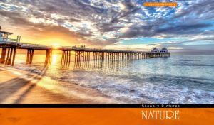 Long pier over the blue ocean in the golden rays of sunset