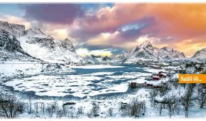 Colorful landscape with a winter lake among Arctic rocks under vivid clouds
