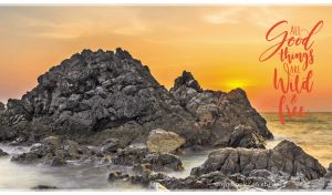 Panoramic scenery of massive rocks in the Atlantic Ocean at orange sunset