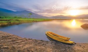 Serene nature scene of an old fishing boat on a lake in golden hours