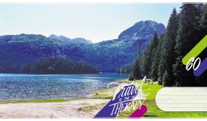Summer scenery with spruce trees along the shore of a mountain lake