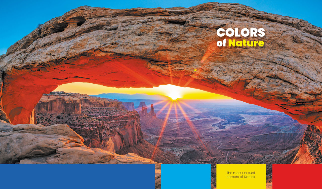 Sunrise at Mesa Arch in hues of yellow and blue