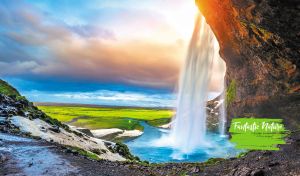 Majestic Seljalandsfoss waterfall cascading into at a golden sunset