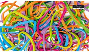 Multicolored rubber bands on a white backdrop