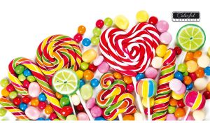 Multicolored lollipops and dragee candies on a white backdrop