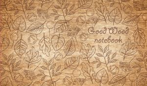 Wood burning art depicting seamless leaf and acorn patterns on a wooden backdrop