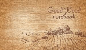Wood burning art depicting cropland and trees on a beige wooden texture
