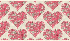 Pink patchwork hearts with floral pattern on a pastel beige polka dot backdrop