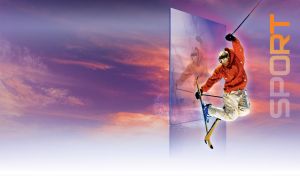 Freestyle skier in red and white suit jumps against purple-white gradient