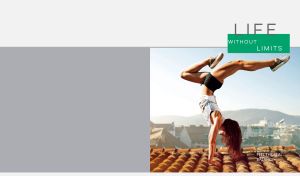 Girl practices handstand on the rooftop against a grey background