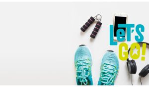 Sneakers, headphones, and a smartphone on a pastel white backdrop