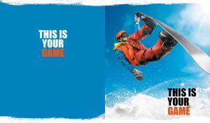 Snowboarding in action against a clear sky on blue and white