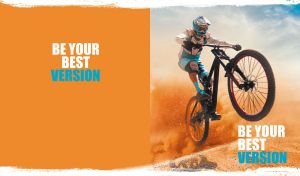 Mountain biking in action in a dusty desert on orange and white