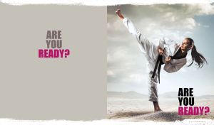 Martial art in action on a dry and cracked land on light grey