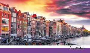 Scenic view of colorful houses and bikes lining the Amsterdam canal at dusk