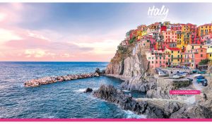 Picturesque coastal Vernazza village with colorful houses on pink and blue