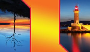 Yellow lighthouse in the sea against the mountains and the blue evening sky