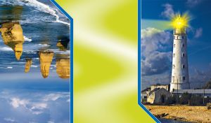 White lighthouse shines with a yellow light against the blue evening sky