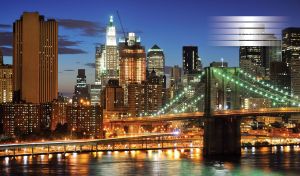 Modern bridge on a dark river in the city lights of skyscrapers and buildings