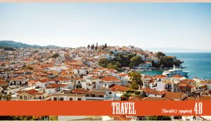 Elevated view of Skiathos harbor in Greece under the white-blue sky