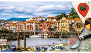 Gorgeous town view of the port of Saint-Jean-de-Luz under the light blue clouds