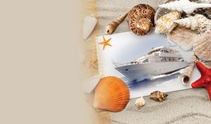 Photo of a white yacht sailing on the ocean lays in the light beige sand