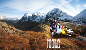 Motorbike racer at a motocross race event in rural mountains and countryside