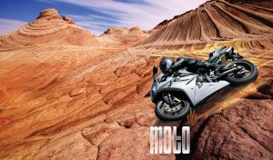 Motorbike racer at a motocross race event in rocky mountain terrain