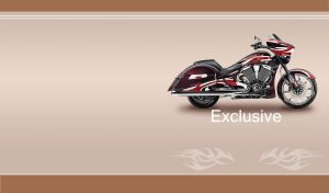 An exclusive red and black chopper motorcycle on a light tan background