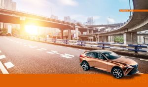 Matte metallic rose gold luxury crossover drives under the interchange viaduct