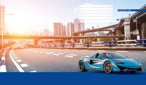 Sky blue sports car drives under the interchange viaduct in the pale sunlight