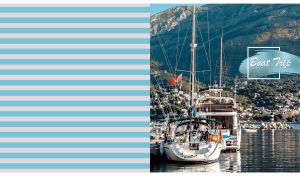 Back view on two moored sailboat on pastel blue and grey striped backdrop