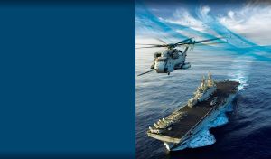 Haze gray helicopter carrier in the navy-blue sea against the morning sky