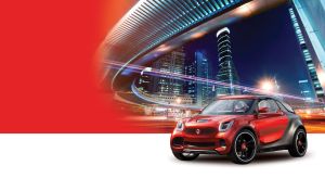 Black and red city coupe against a blue cityscape with illuminated modern bridge