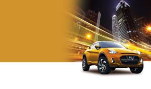 Golden subcompact SUV against a black cityscape lit by orange lights