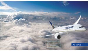 Front view of a white airplane above the white clouds in the blue sky
