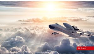 The An-225 Mriya airplane flies above the navy-gray clouds in the sun rays