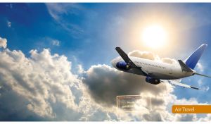 Rear view of a white and blue airplane above the white clouds in the blue sky