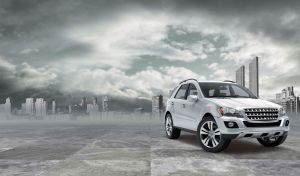 Light grey metallic SUV against the urban stormy-sky background