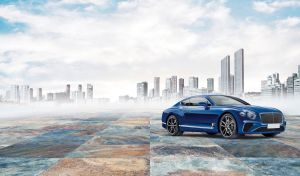 Ultramarine blue GT coupe against white and blue background of urban mist