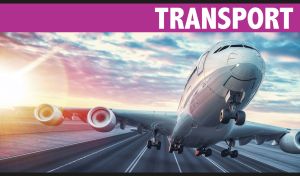 A white airplane front view taking off from a runway at sunset