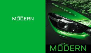 Close-up of an emerald green modern sports car headlight on green